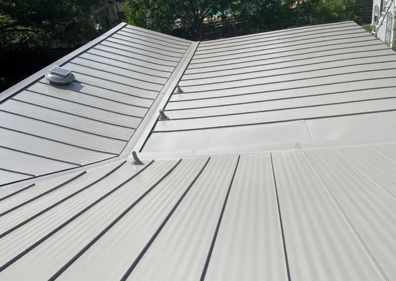 Solar attic fan installed on a metal roof for Roof Ventilation in Sterling